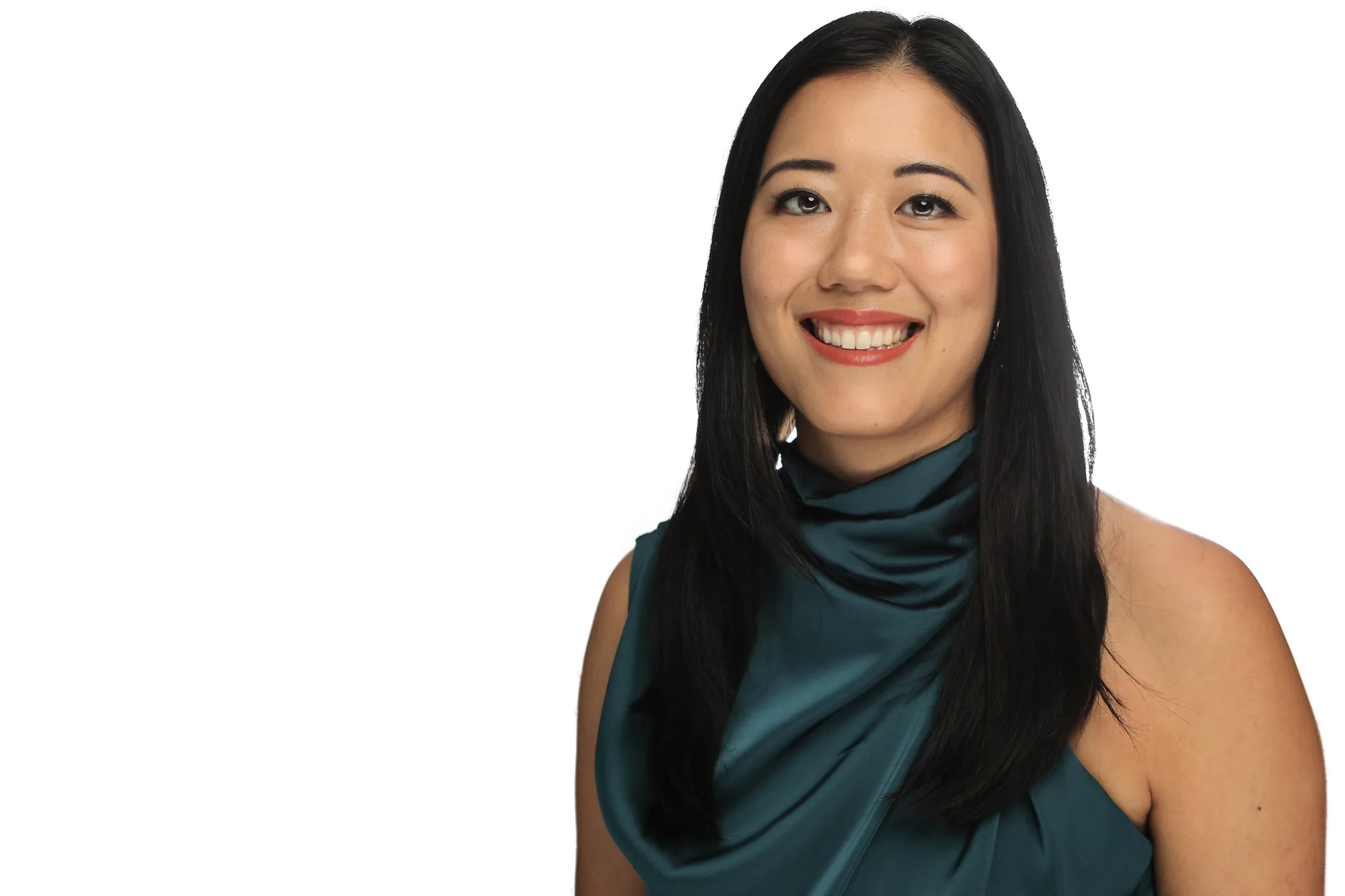 Corporate headshot of a woman in teal on a white background