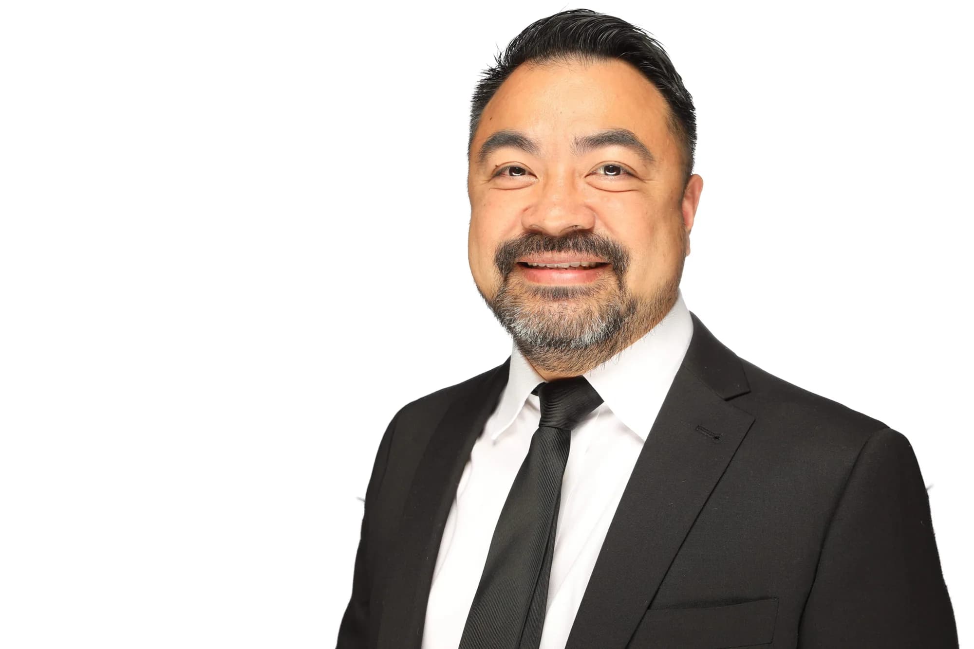 Corporate headshot of a man in a dark suit on a white background