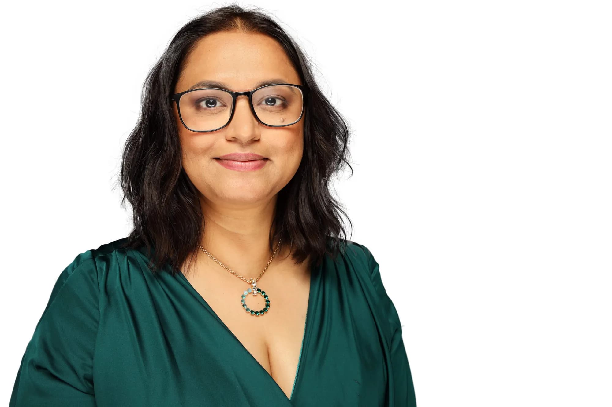 Corporate headshot of a woman in green on a white background