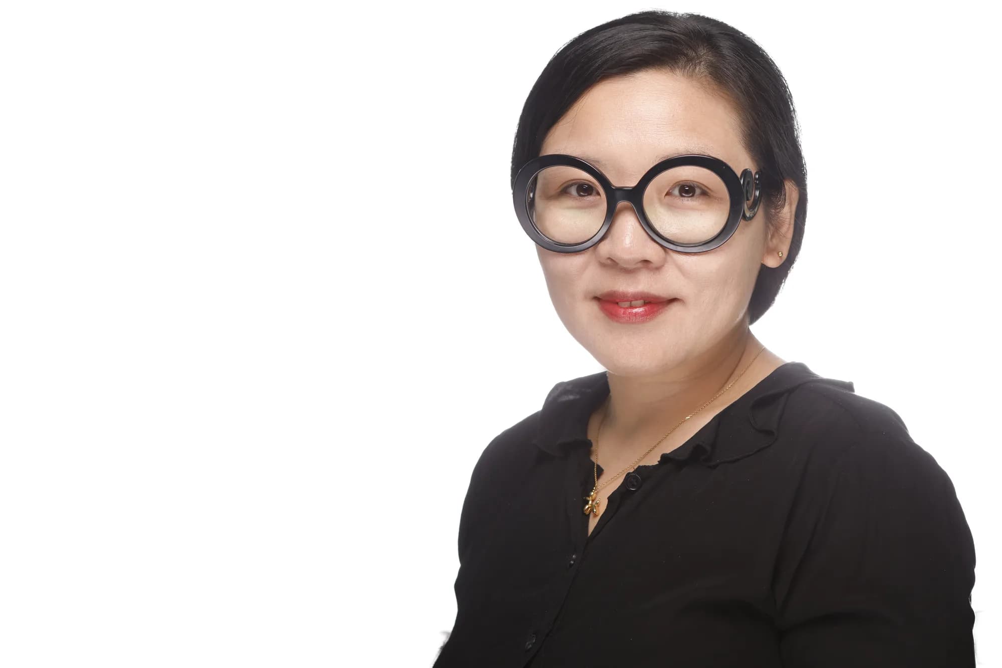 Corporate headshot of a woman in glasses on a white background