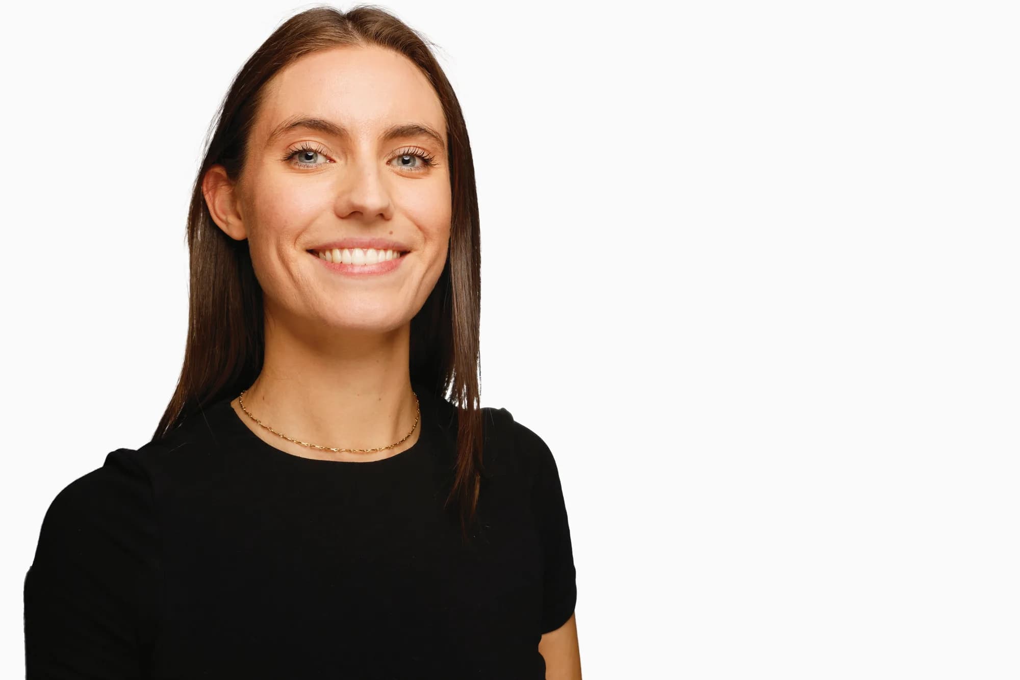 Corporate headshot of a woman in black on a white background