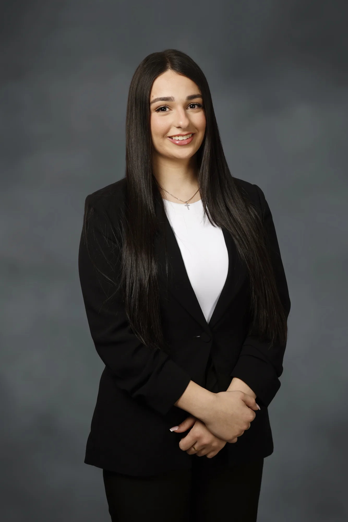 Corporate portrait of a woman on a dark studio backdrop