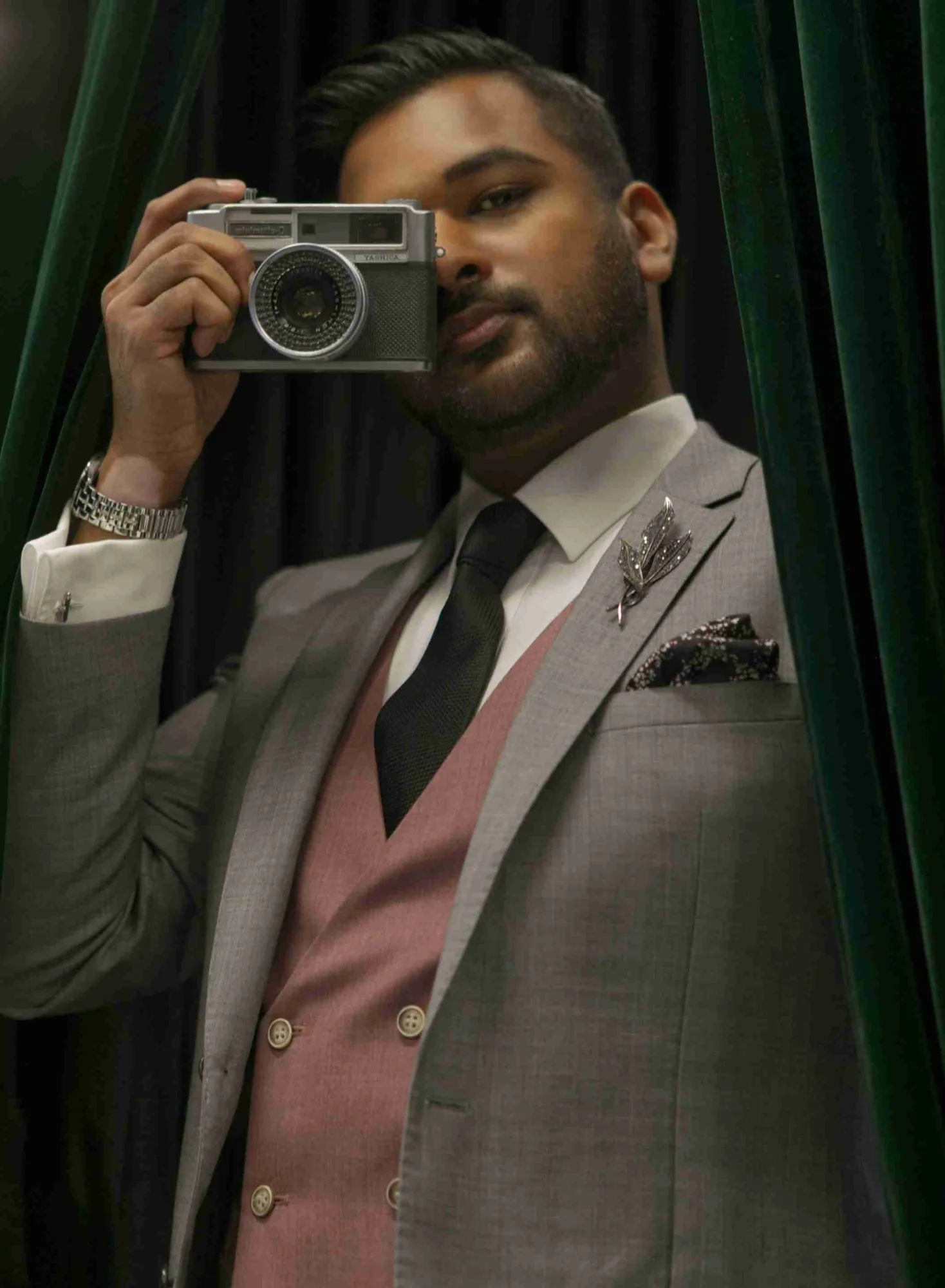 Editorial portrait of a man holding a camera in moody light, Sydney