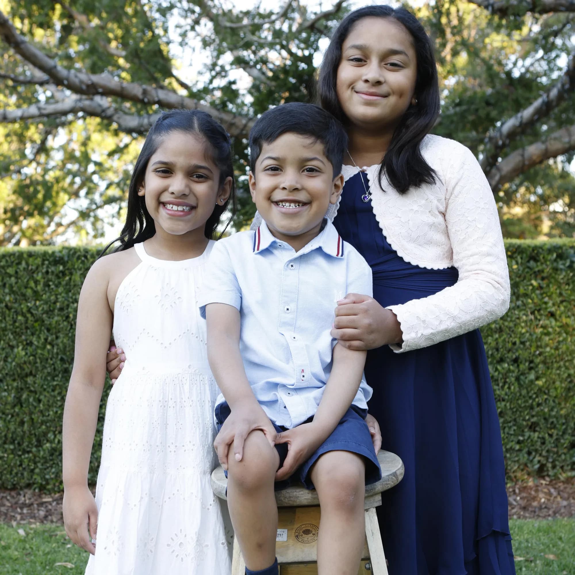 Three siblings photographed together outdoors, Sydney