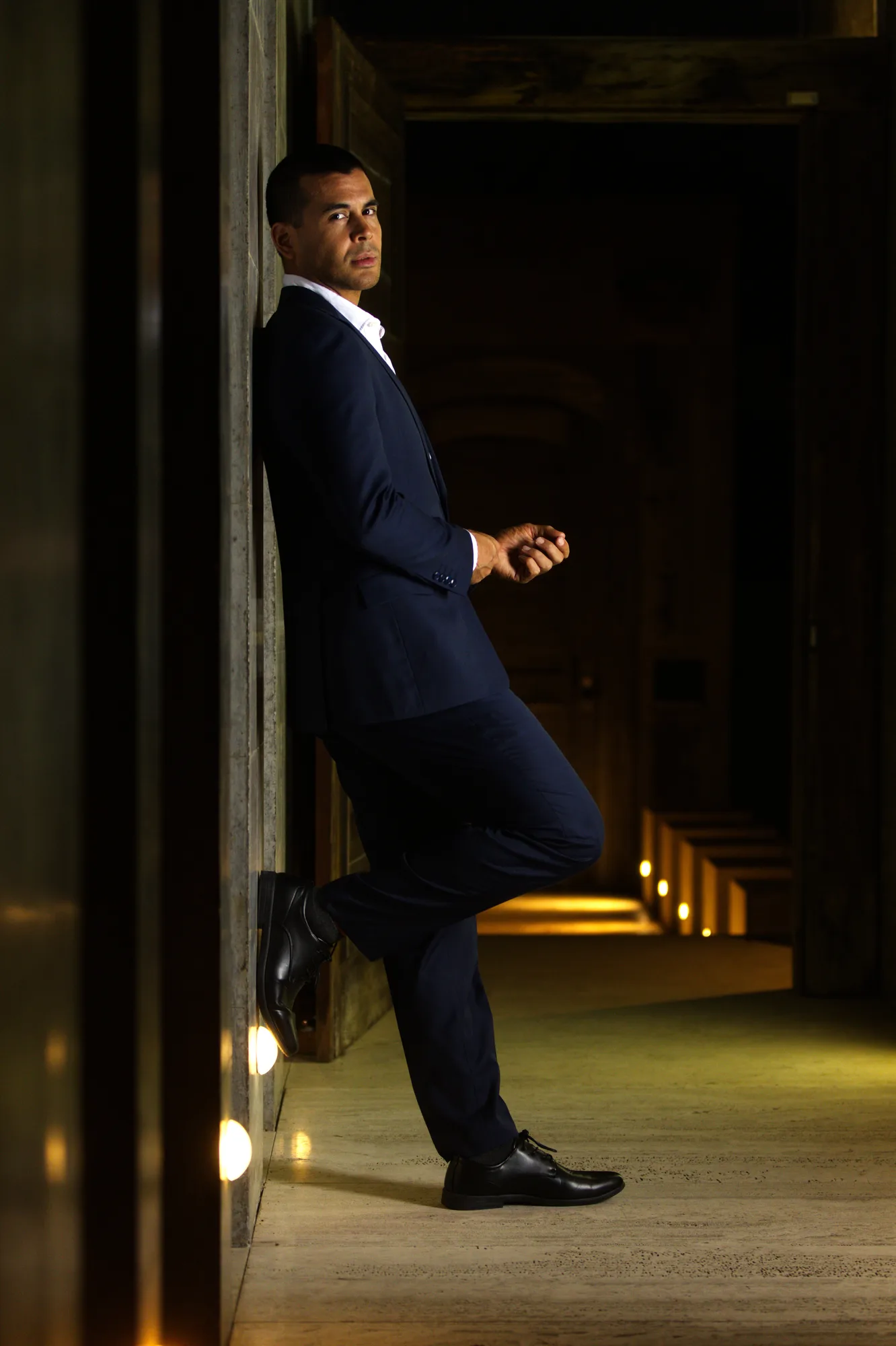 Moody full-length model portfolio portrait of a man in a navy suit, Sydney